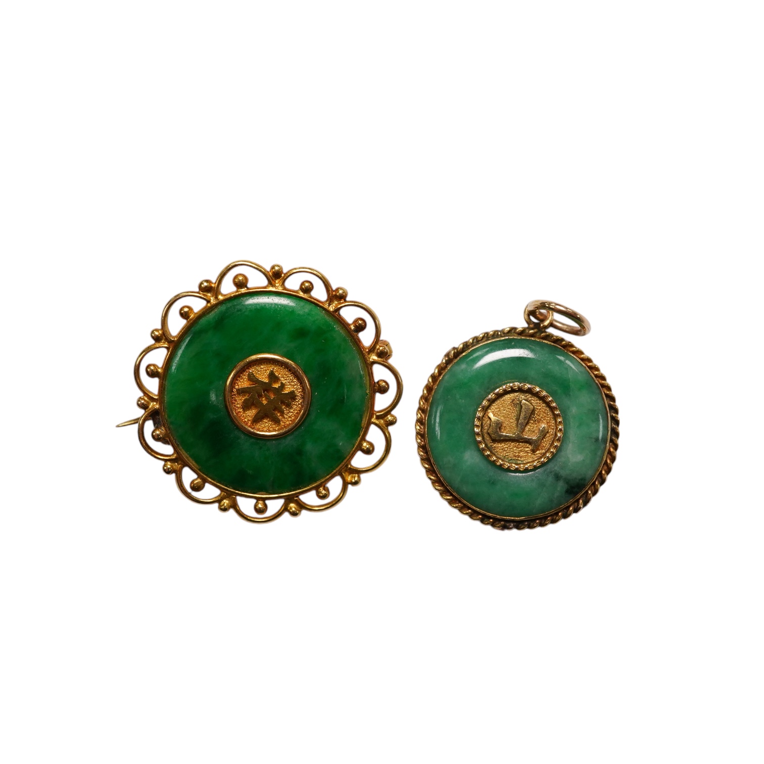 A Chinese 18k and jade set circular brooch, 23mm and a similar yellow metal and jade set pendant, gross weight 5.3 grams. Condition - fair